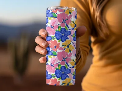 Tumbler with a floral pattern of pink, blue, and yellow flowers.
