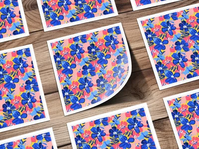 Floral pattern stickers with blue flowers and pink accents on a wooden background.