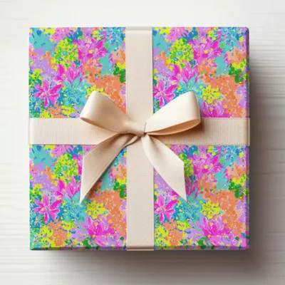 Gift-wrapped box with colorful floral pattern and cream ribbon.