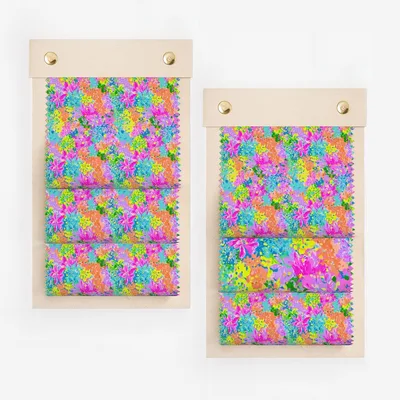 Two fabric swatch samples displaying a vibrant, abstract floral pattern in bright colors.