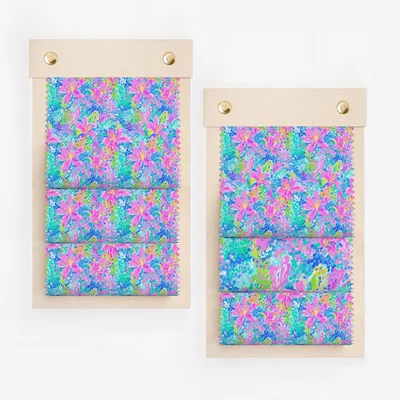 Two fabric swatches with vibrant floral pattern in pink, blue, and green.