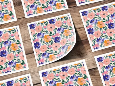 Floral pattern with pink, purple, and orange flowers on a wooden background.