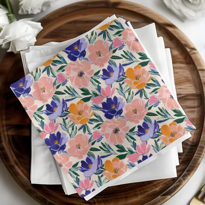 Floral patterned napkins with pink, blue, and orange flowers on a wooden tray.