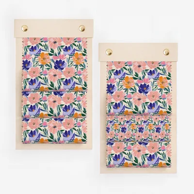 Fabric swatches with floral pattern on a wooden board.