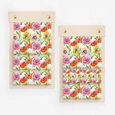 Fabric swatches with pink and yellow floral pattern on a wooden display.