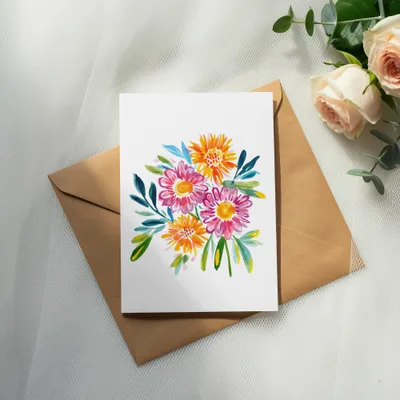 Watercolor bouquet of pink and orange flowers on a card over a brown envelope.
