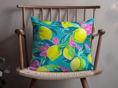 Turquoise throw pillow with a vibrant lemon and floral pattern.