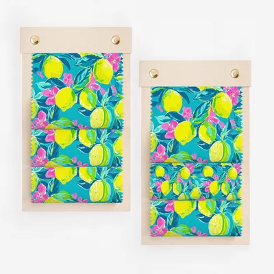 Two swatches of turquoise fabric with a vibrant lemon and pink floral print.
