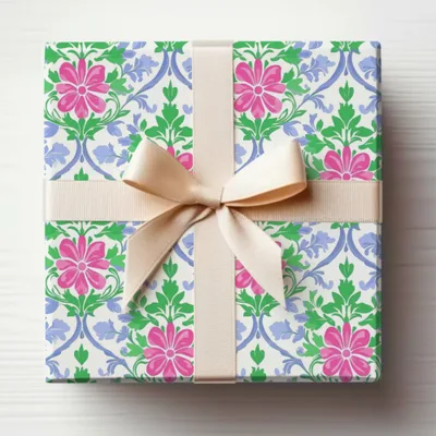 Gift-wrapped box with pink flowers and blue vines, tied with a beige ribbon.