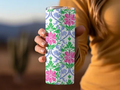 White tumbler with pink flowers and blue scrolling floral pattern.