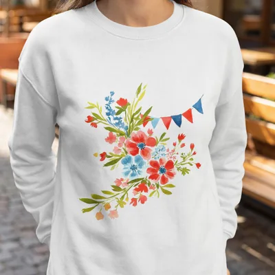 White sweatshirt with a watercolor floral bouquet and a string of red, white, and blue pennants.