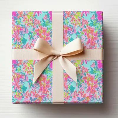 Gift box with a colorful floral pattern and a beige ribbon bow.
