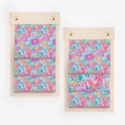 Two swatch books with colorful floral fabric samples.