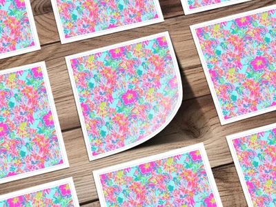 Floral pattern cards with pink, blue, and green flowers on a wooden surface.