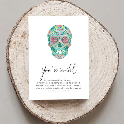 Decorative floral sugar skull invitation with "You're invited" text.