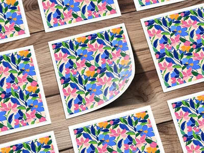 Floral patterned cards with blue, pink, and green flowers on a wooden background.