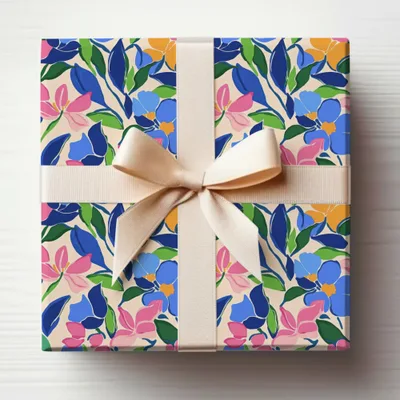 Gift-wrapped box with a floral pattern and a light brown ribbon.