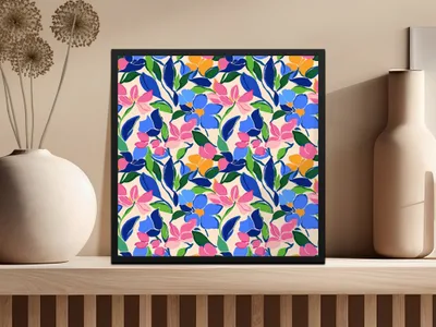 Framed artwork with a colorful floral pattern on a shelf.
