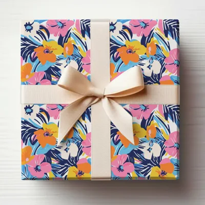 Gift-wrapped box with a colorful floral pattern and a light beige ribbon.