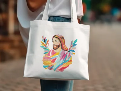Jesus with colorful abstract wings on a white canvas tote bag.