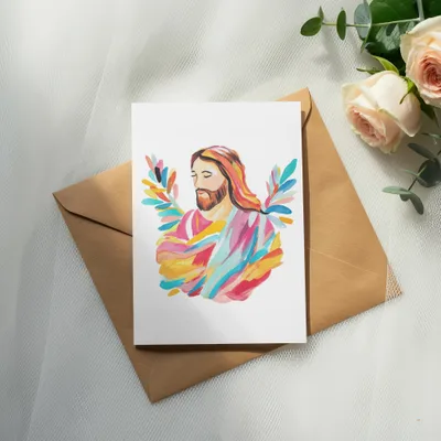 Painting of Jesus with colorful halo, on brown envelope with roses.