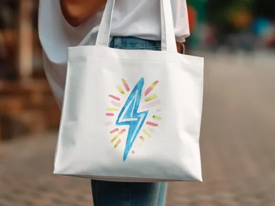 White canvas tote bag with a watercolor lightning bolt graphic.