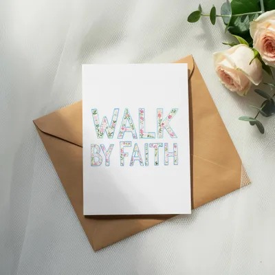 Card with "WALK BY FAITH" text in floral lettering on an envelope.