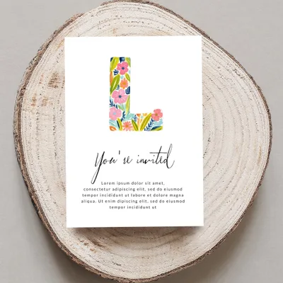 Invitation card with large floral letter L, "You're invited" text, and placeholder copy.