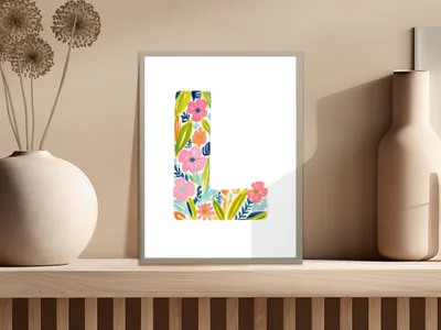 Letter L art print with colorful floral illustrations on a wooden shelf.