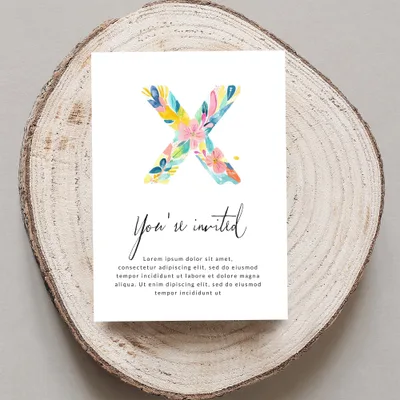Invitation with watercolor floral "X" and placeholder text.