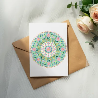 Card with colorful floral mandala design on brown envelope, with roses and eucalyptus.