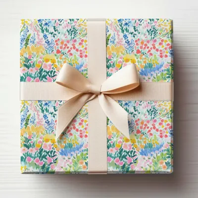 Wrapped gift box with colorful floral pattern and cream ribbon bow.