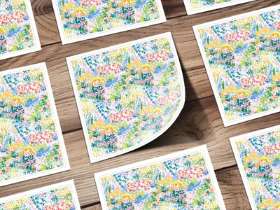 Floral pattern stationery cards scattered on a wooden surface.