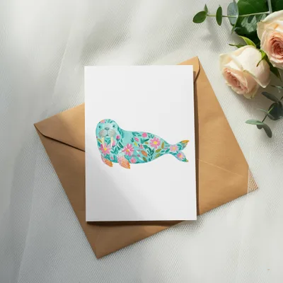 Card with floral walrus illustration on kraft envelope, with roses.