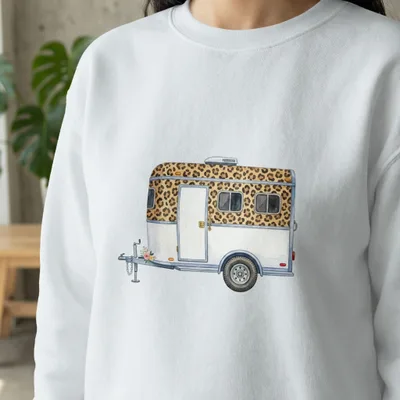 White sweatshirt with watercolor print of a leopard print and white travel trailer.