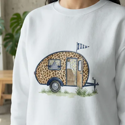 White sweatshirt with a watercolor illustration of a leopard print camper trailer.