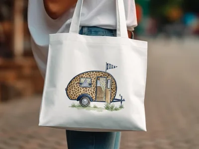 White tote bag featuring a watercolor illustration of a leopard print camper trailer.