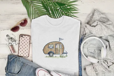 White t-shirt with a watercolor graphic of a leopard-print camper trailer.