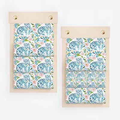 Swatches of blue leopard print fabric with pink and green floral accents.