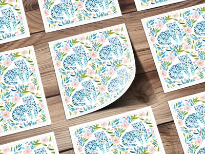Pattern of blue watercolor leopards with pink and green flowers.
