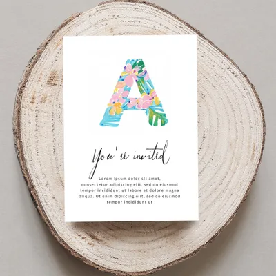 Floral letter A on invitation with "You're invited" text.