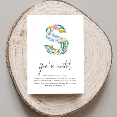 Invitation with floral letter S and placeholder text.
