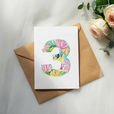 Card with colorful tropical pattern number 3 on a kraft envelope.