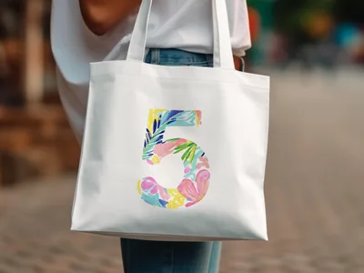 White canvas tote bag with a colorful floral number 5 design.