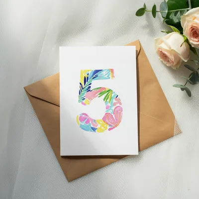 Card with colorful floral "5" design on brown envelope with roses.