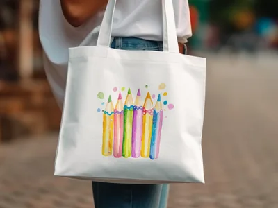 White tote bag with a colorful watercolor illustration of sharpened pencils.