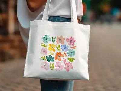 White tote bag with a grid of colorful watercolor flowers.
