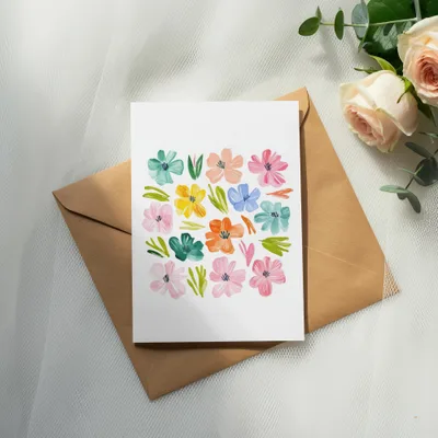 Card with colorful floral illustration on a kraft envelope.
