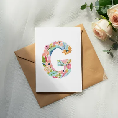 Card with watercolor letter G on an envelope, with roses.