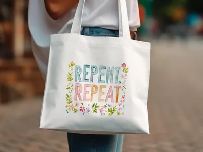 White tote bag with "REPENT. REPEAT." in colorful watercolor lettering.